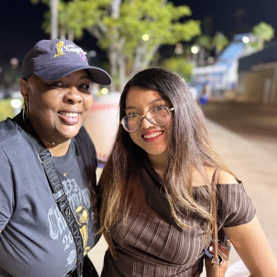 Two women smiling together at an evening outing